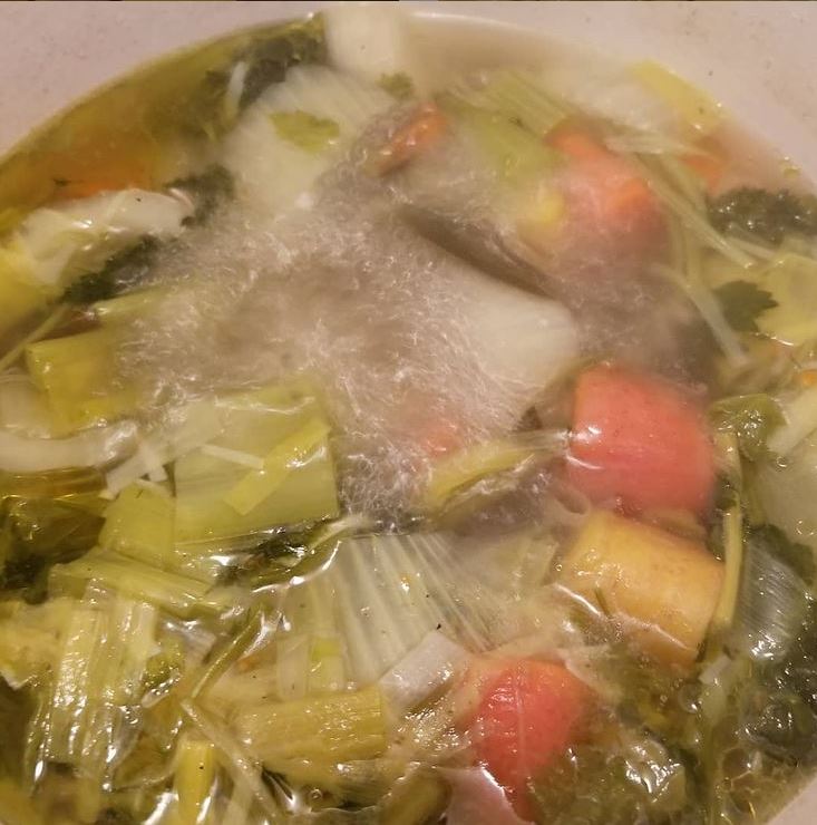 Soup stock boiling in a pot.