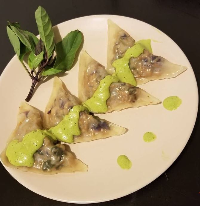 Dumplings with green curry sauce